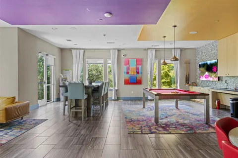 a living room with furniture a window and a table