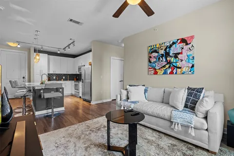 a living room with furniture and kitchen view