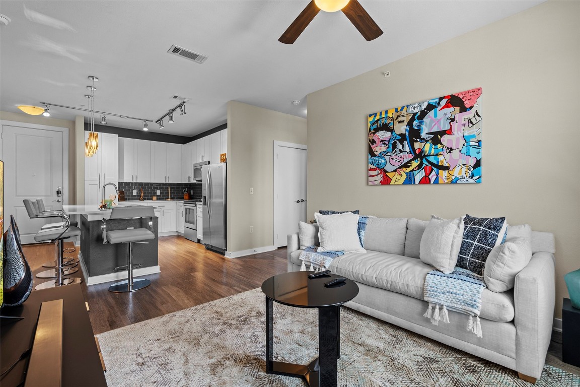 1900 Barton Springs Road, Unit 5027 Austin, TX 78704 - Photo 2 of 28 a living room with furniture and kitchen view