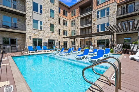 a view of an swimming pool with outdoor seating