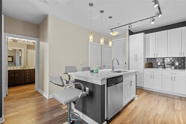 a kitchen with a sink cabinets and wooden floor
