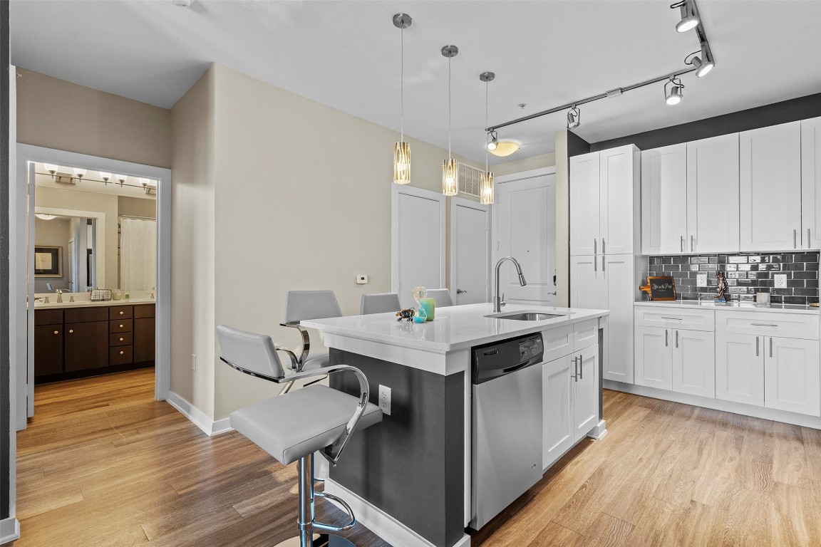 1900 Barton Springs Road, Unit 5027 Austin, TX 78704 - Photo 6 of 28 a kitchen with a sink cabinets and wooden floor