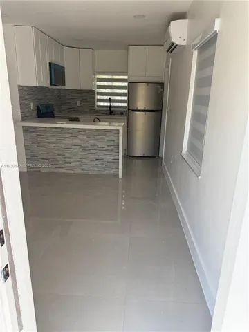 a kitchen with stainless steel appliances a refrigerator and a stove