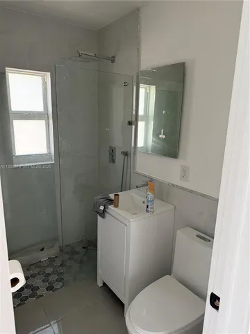 a bathroom with a sink mirror and toilet