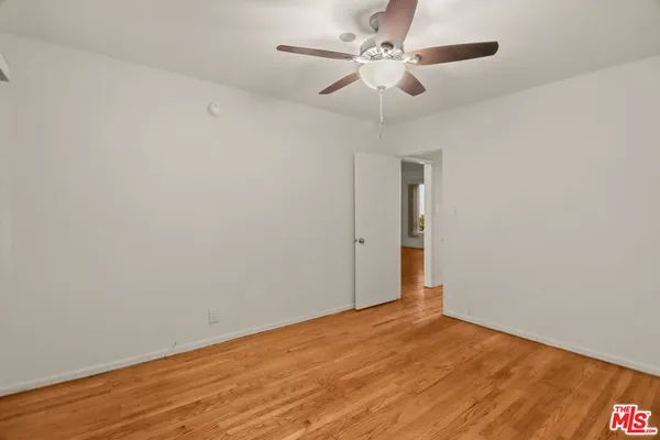a view of an empty room with a fan