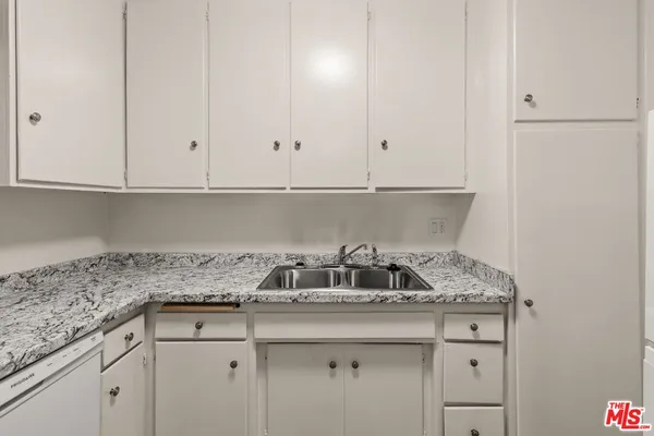 a kitchen with a sink and cabinets