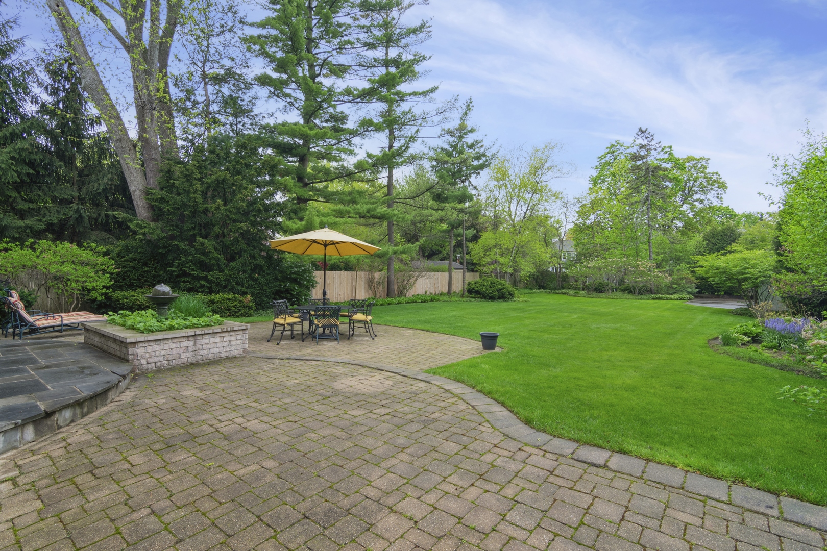 1111 Seneca Road Wilmette, IL 60091 - Photo 14 of 50 a view of a yard with a table and chairs under an umbrella
