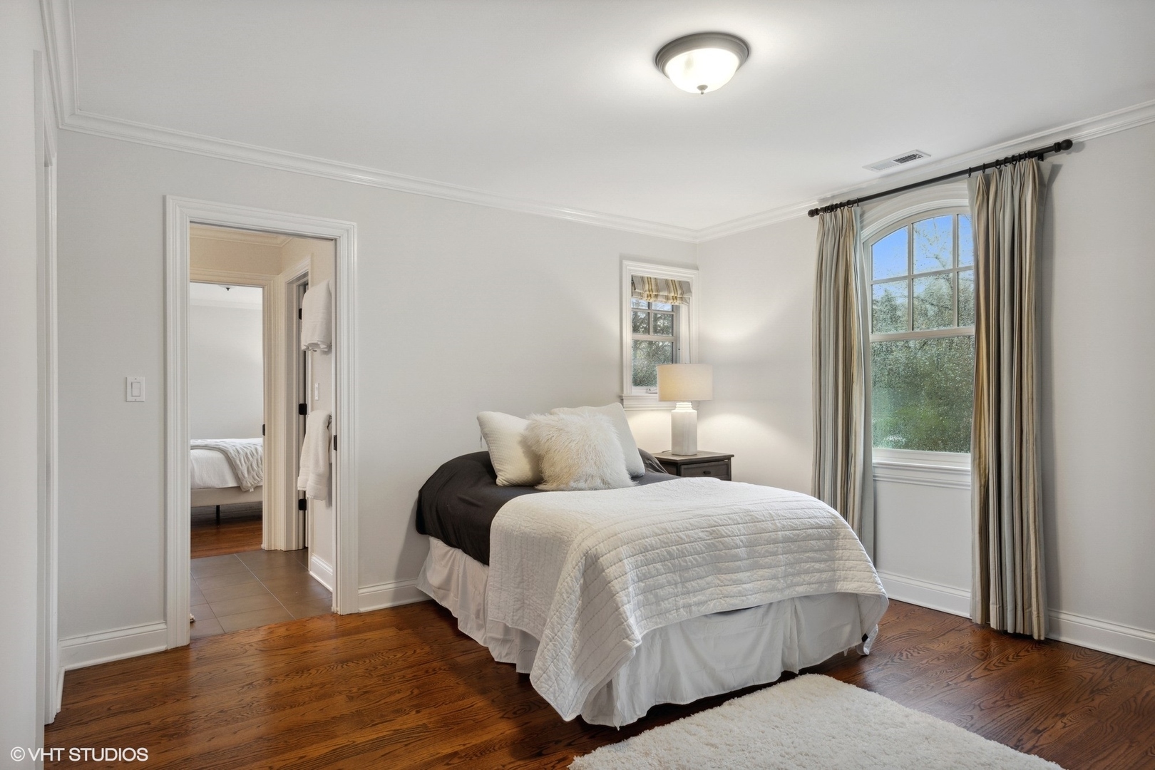 1111 Seneca Road Wilmette, IL 60091 - Photo 31 of 50 a bedroom with a bed and wooden floor