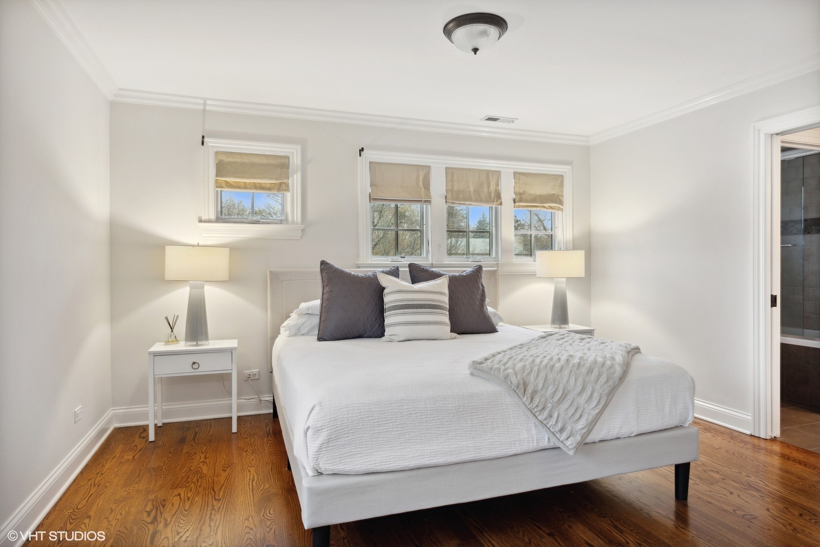 1111 Seneca Road Wilmette, IL 60091 - Photo 33 of 50 a bedroom with a bed and wooden floor