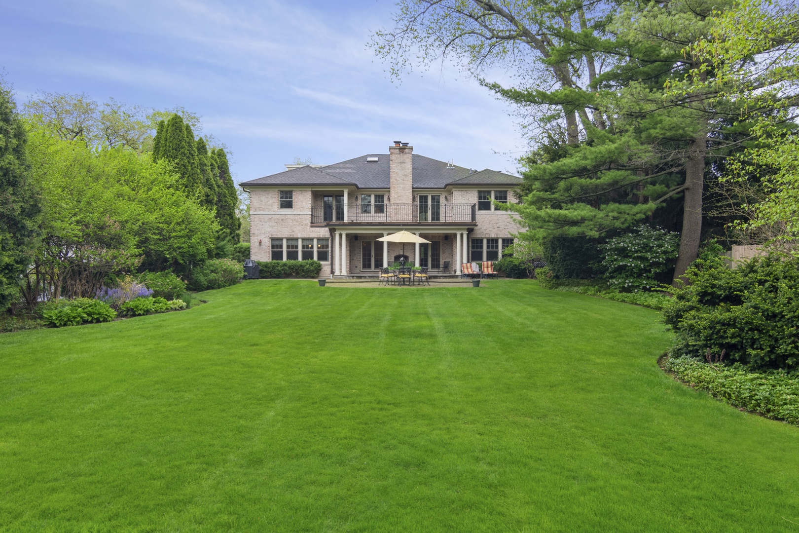 1111 Seneca Road Wilmette, IL 60091 - Photo 44 of 50 a front view of a house with a yard table and chairs