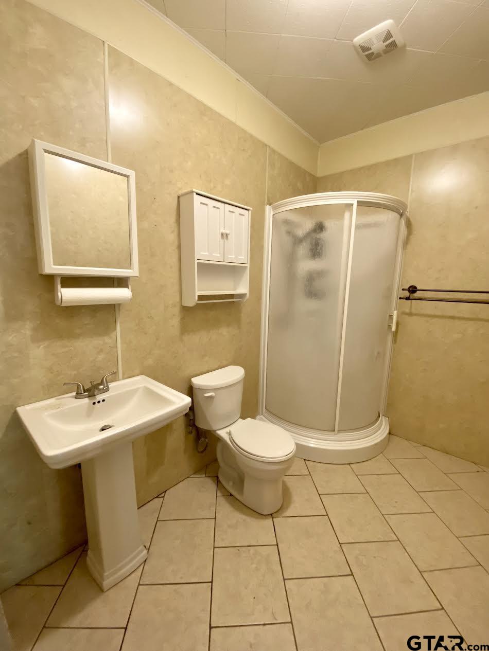 23120 Saddle Ridge Court Lindale, TX 75771 - Photo 33 of 34 a bathroom with a sink a toilet and shower