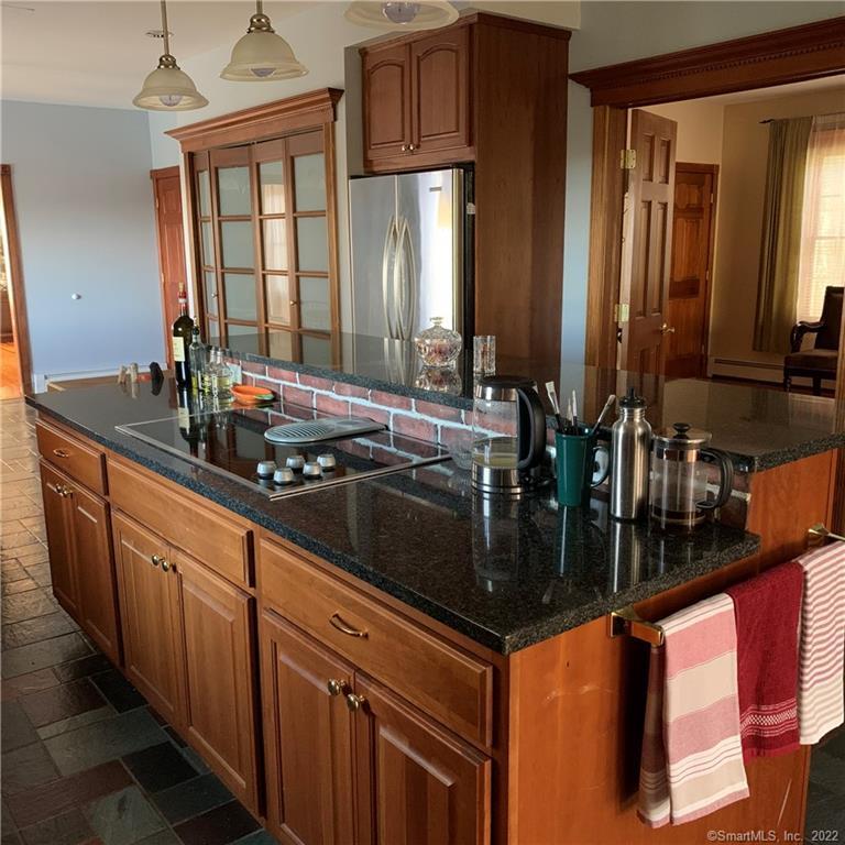 38 Merriman Lane Prospect, CT 06712 - Photo 11 of 35 a kitchen with granite countertop a sink and a wooden cabinets