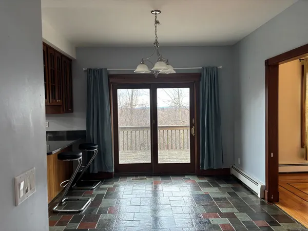 a view of a room with a window and furniture