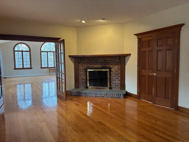 a living room with wooden floors and a fireplace