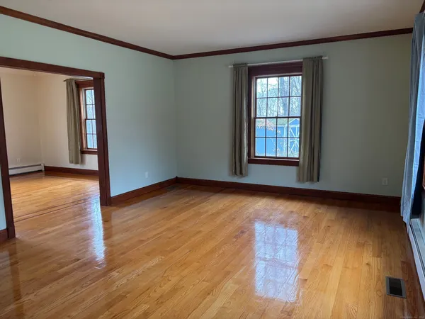 a view of a room with wooden floor and a window