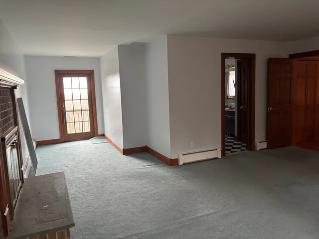 a view of a room with a table and chairs