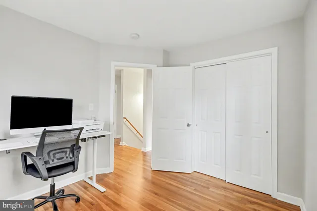 a view of a workspace with furniture and wooden floor