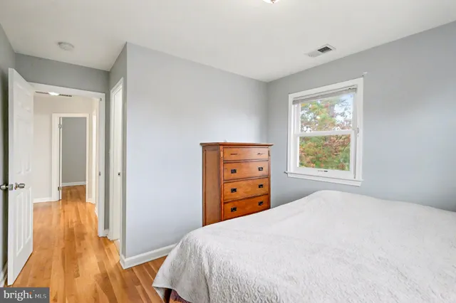 a bedroom with a bed and a dresser