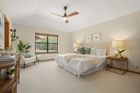 a spacious bedroom with a bed and a window
