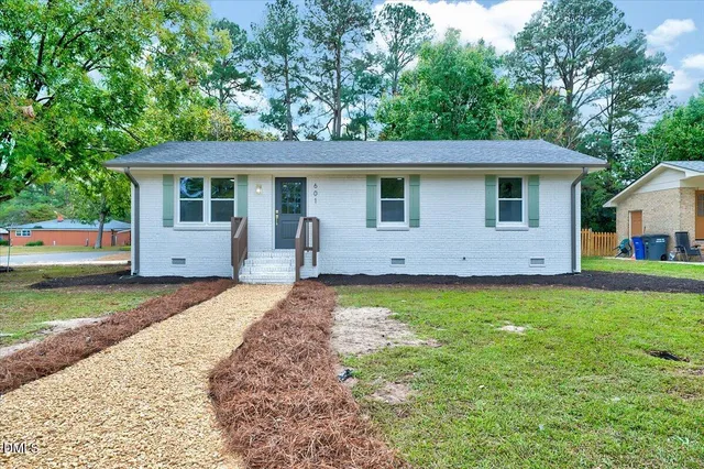 a front view of house with yard and trees