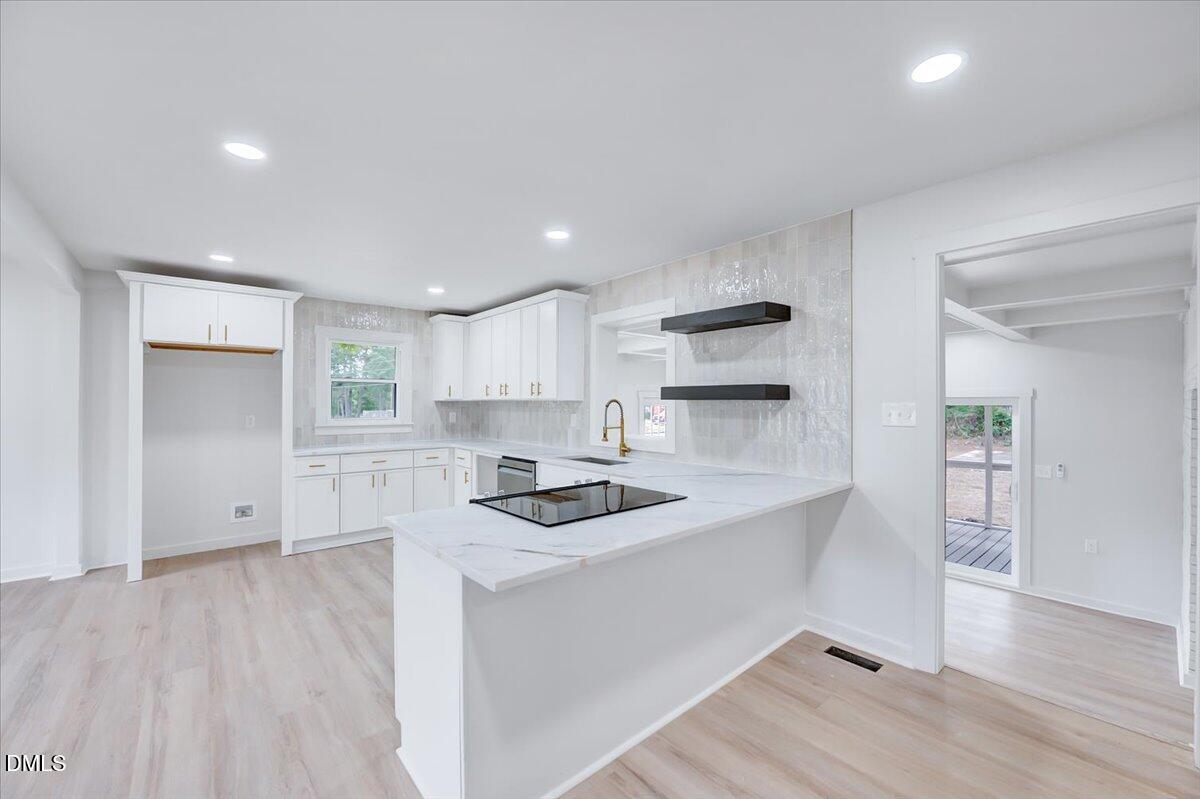 601 West Walnut Street Selma, NC 27576 - Photo 9 of 30 a kitchen with granite countertop a sink cabinets and wooden floor