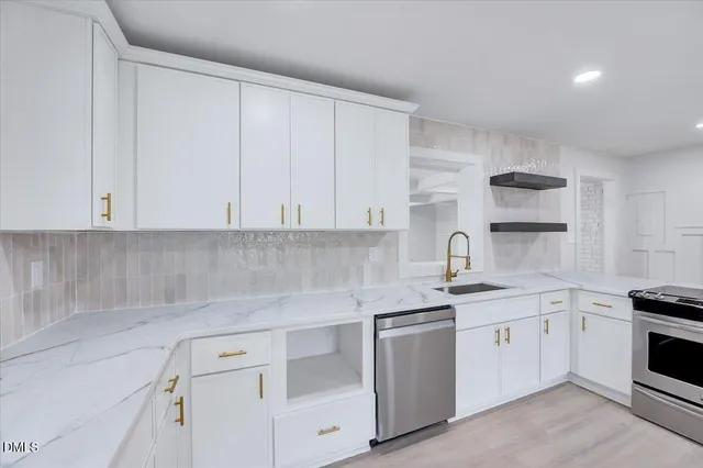 a kitchen with granite countertop a sink cabinets and wooden floor