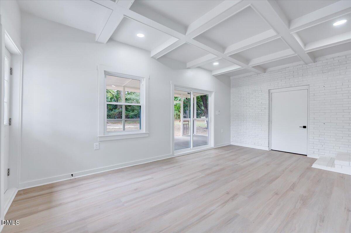 601 West Walnut Street Selma, NC 27576 - Photo 12 of 30 an empty room with wooden floor and windows