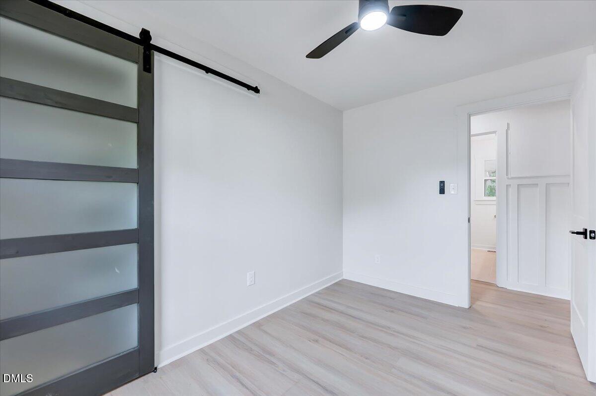 601 West Walnut Street Selma, NC 27576 - Photo 16 of 30 a view of an empty room with wooden floor