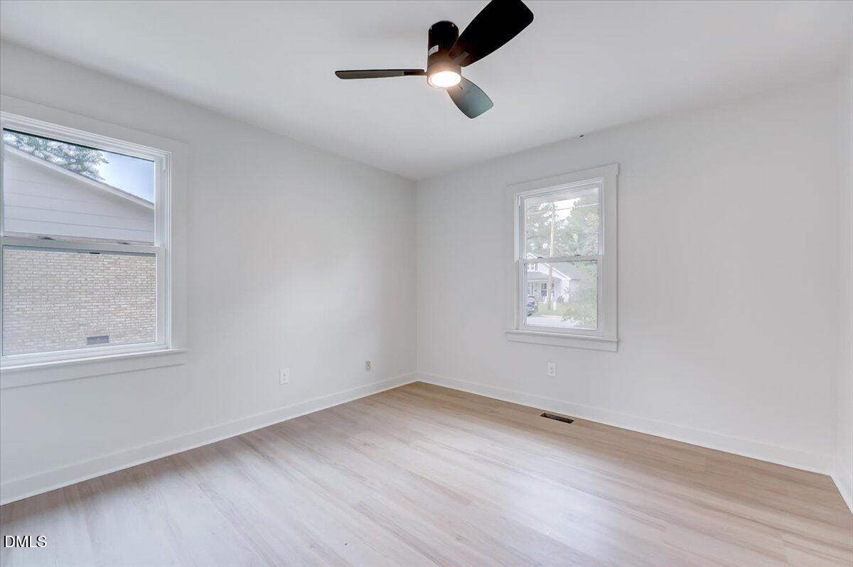 601 West Walnut Street Selma, NC 27576 - Photo 17 of 30 wooden floor in an empty room with a window