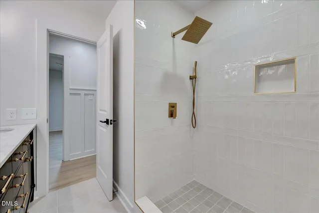 a bathroom with a granite countertop sink a toilet and a mirror