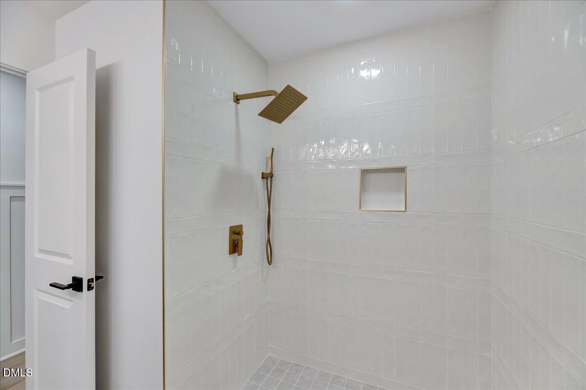 601 West Walnut Street Selma, NC 27576 - Photo 21 of 30 a bathroom with a shower and a ceiling fan