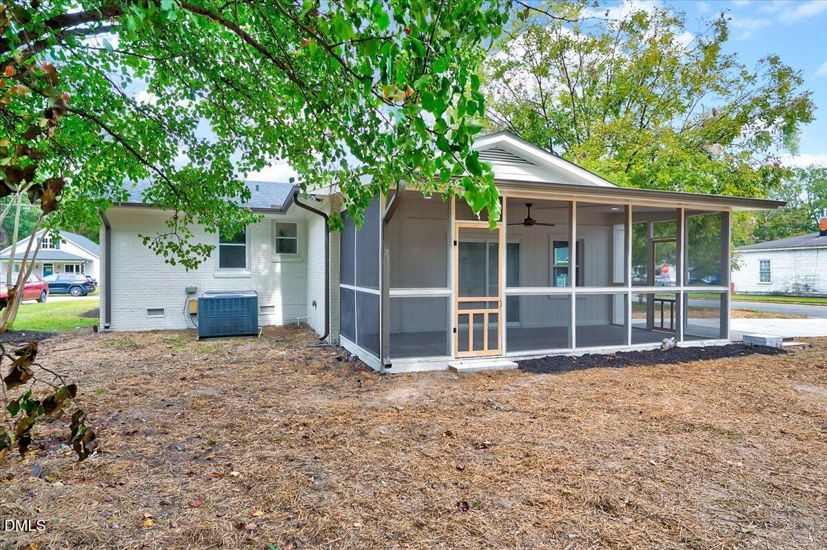 601 West Walnut Street Selma, NC 27576 - Photo 23 of 30 a view of a house with a yard and large tree