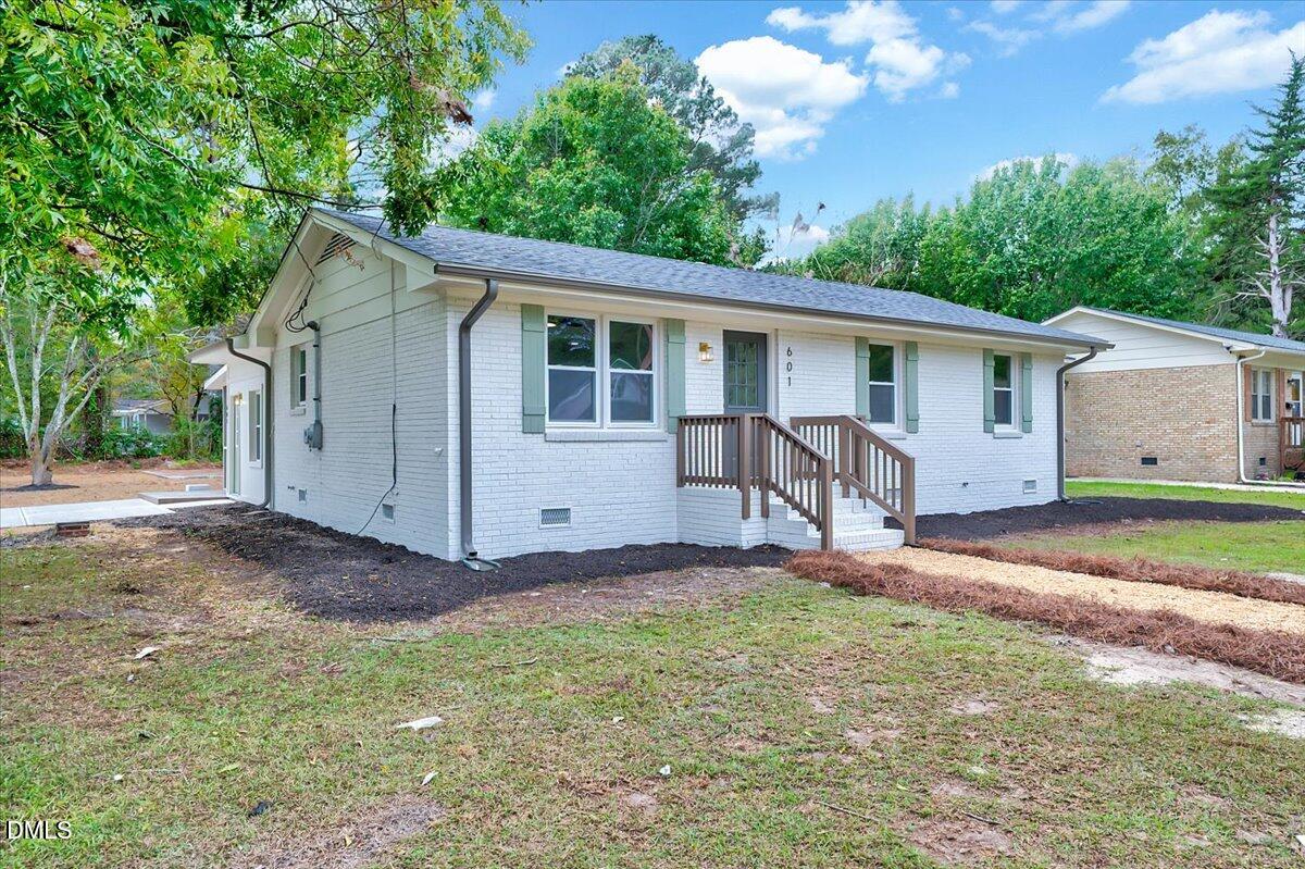 601 West Walnut Street Selma, NC 27576 - Photo 2 of 30 a view of a house with a yard and large tree