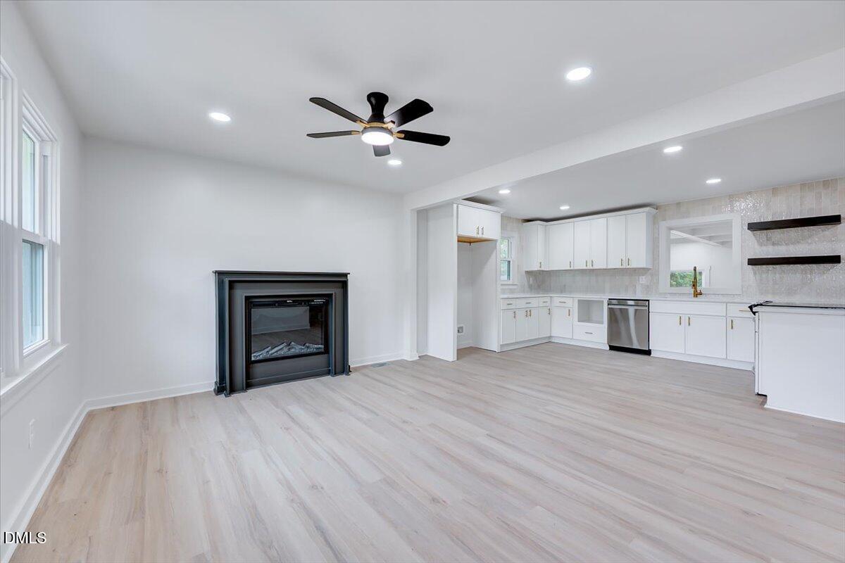 601 West Walnut Street Selma, NC 27576 - Photo 5 of 30 a view of a kitchen with a sink hardwood floor and a kitchen
