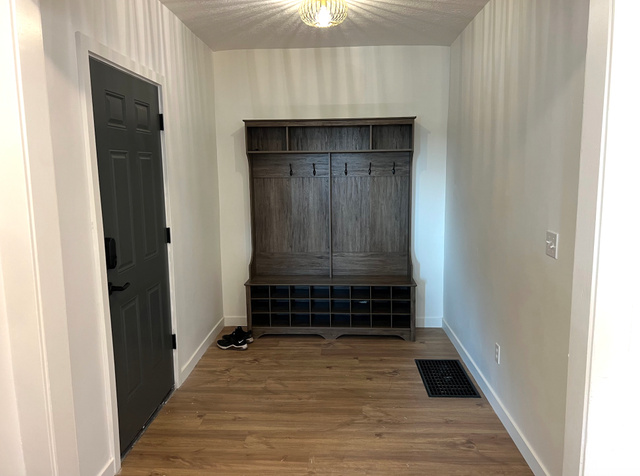 545 23rd Street Ogden, UT 84401 - Photo 9 of 28 Entry area featuring wood-finish flooring and a built-in hall tree with storage cubbies and coat hooks