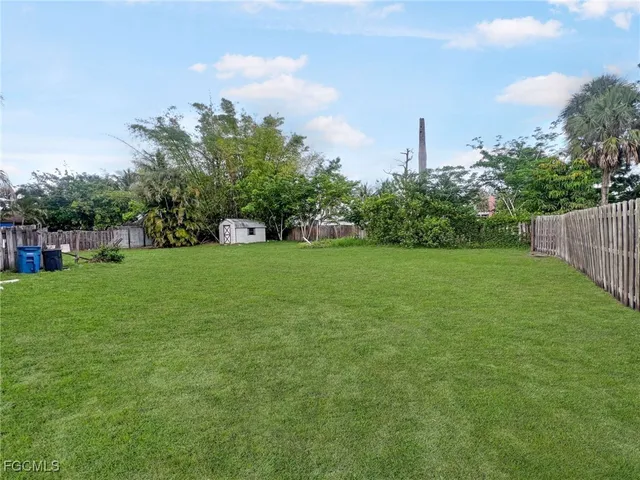 a view of a garden with a building in the background