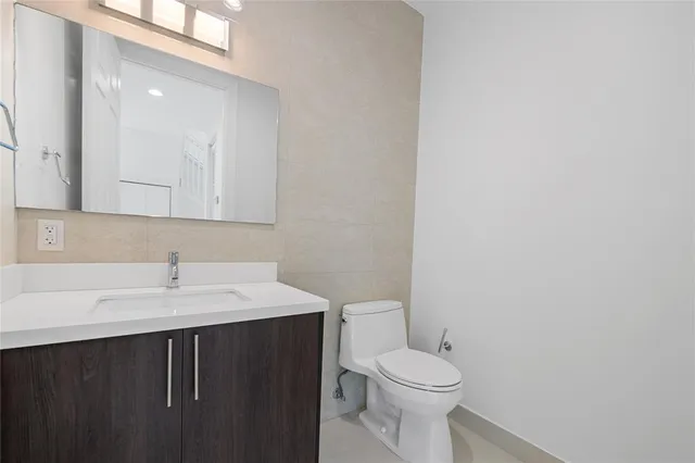 a bathroom with a sink a toilet and mirror