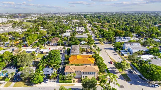 an aerial view of residential houses with outdoor space and street view