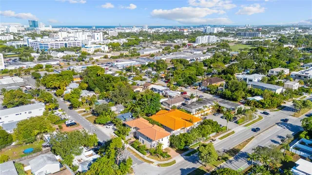 an aerial view of residential houses with outdoor space and swimming pool