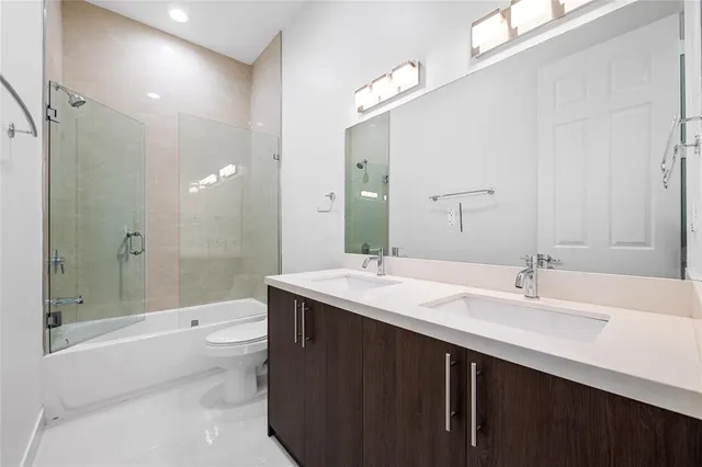 a bathroom with a double vanity sink mirror double shower and a bathtub