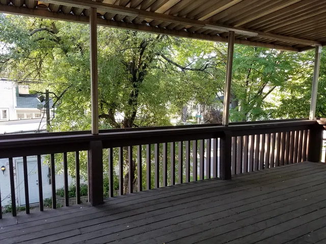 a view of balcony with wooden floor