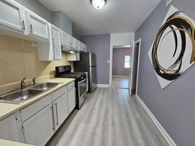a kitchen with a sink and a stove