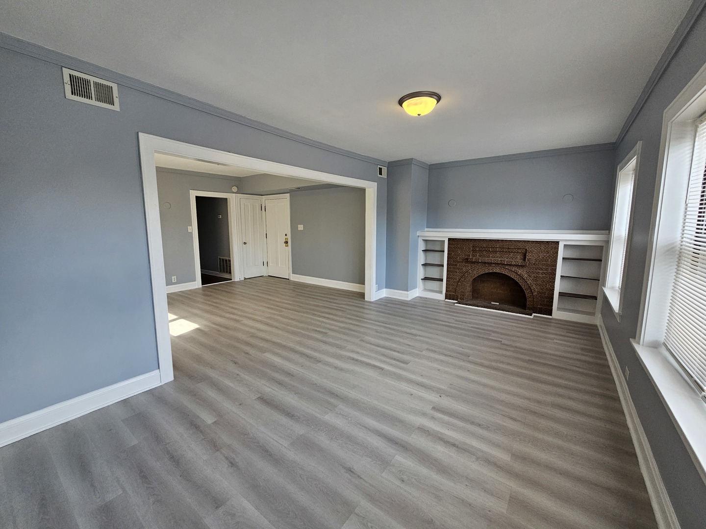 6600-04 West Roosevelt Road West Oak Park, IL 60304 - Photo 19 of 23 an empty room with wooden floor and a fireplace