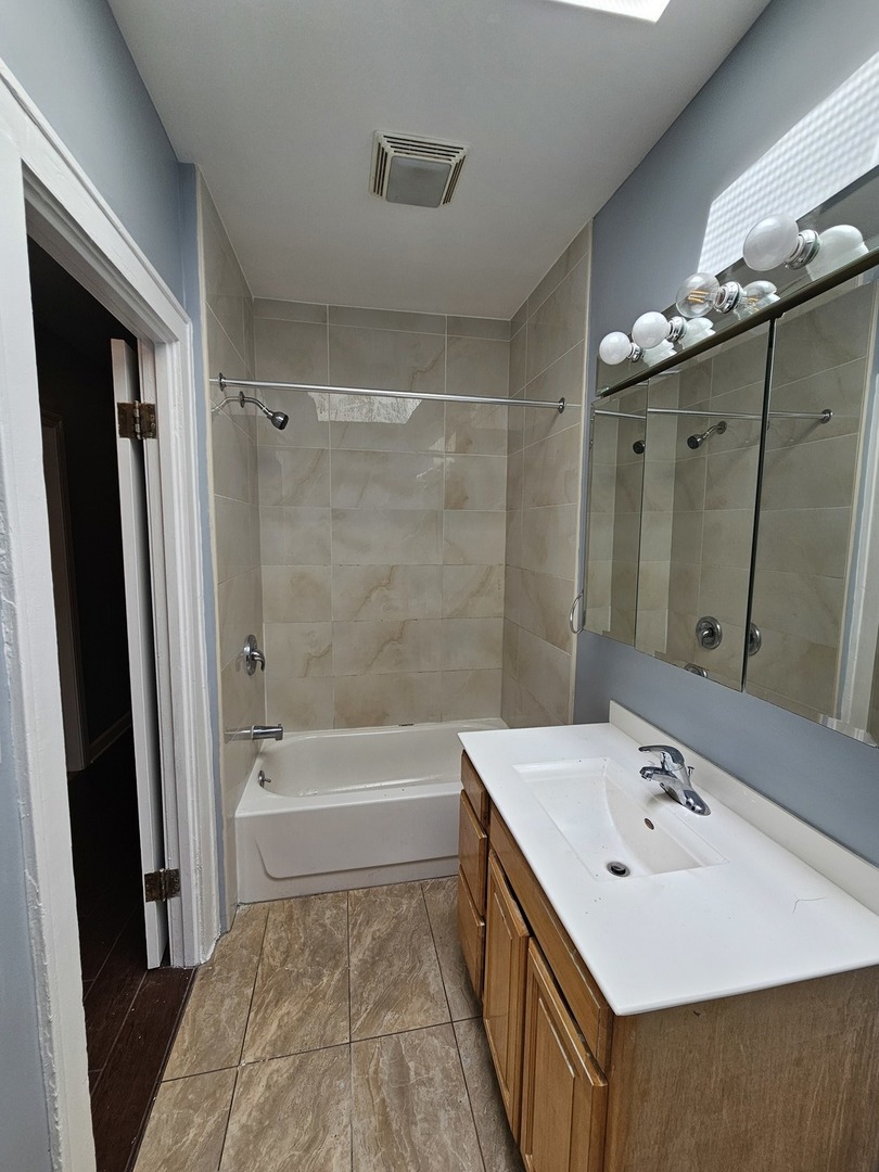 6600-04 West Roosevelt Road West Oak Park, IL 60304 - Photo 21 of 23 a bathroom with a tub sink and mirror