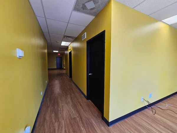 a view of hallway with wooden floor