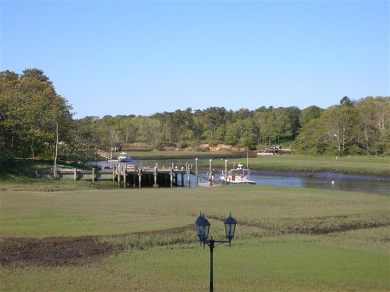 161 Route 28, Unit 7 West Harwich, MA 02671 - Photo 12 of 16 a view of a lake with houses in the back