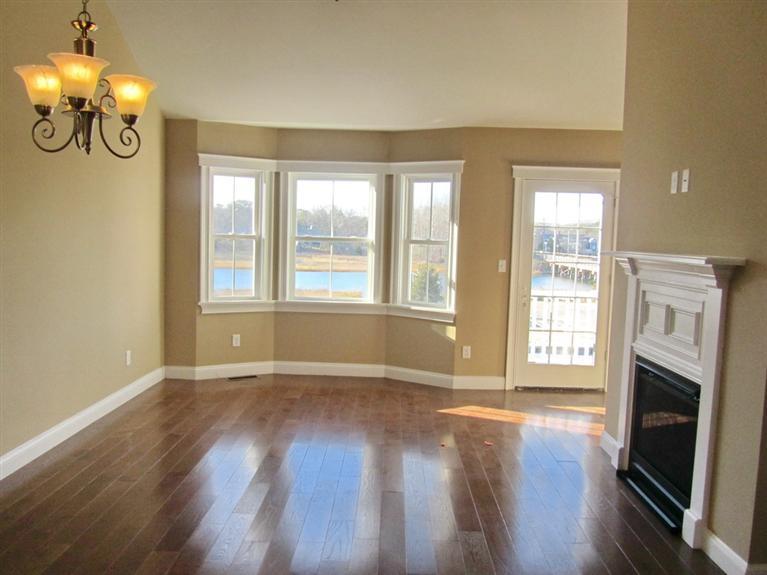 161 Route 28, Unit 7 West Harwich, MA 02671 - Photo 4 of 16 a view of an empty room with wooden floor and a window