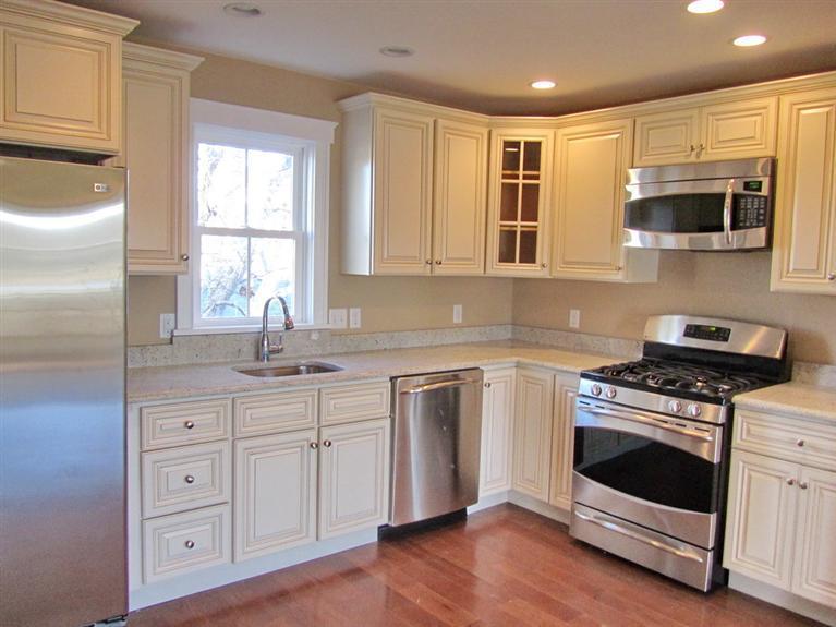 161 Route 28, Unit 7 West Harwich, MA 02671 - Photo 5 of 16 a kitchen with stainless steel appliances granite countertop a stove a sink and a microwave