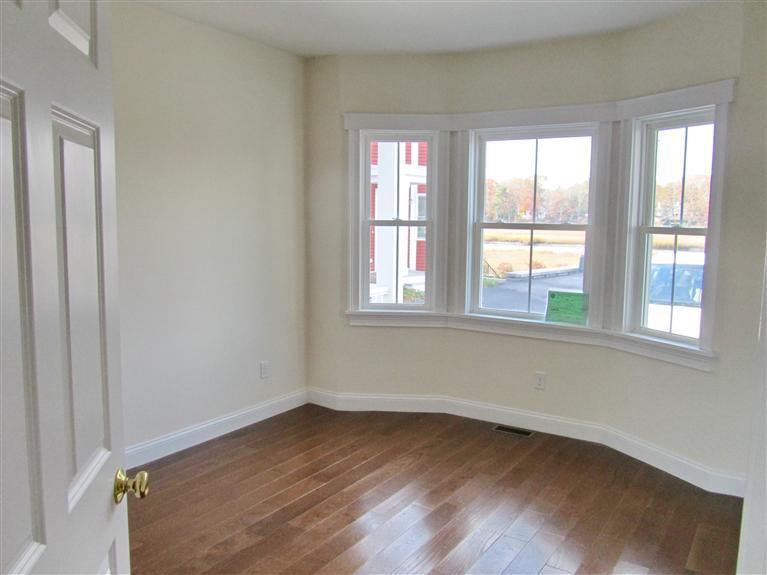161 Route 28, Unit 7 West Harwich, MA 02671 - Photo 8 of 16 an empty room with wooden floor and windows