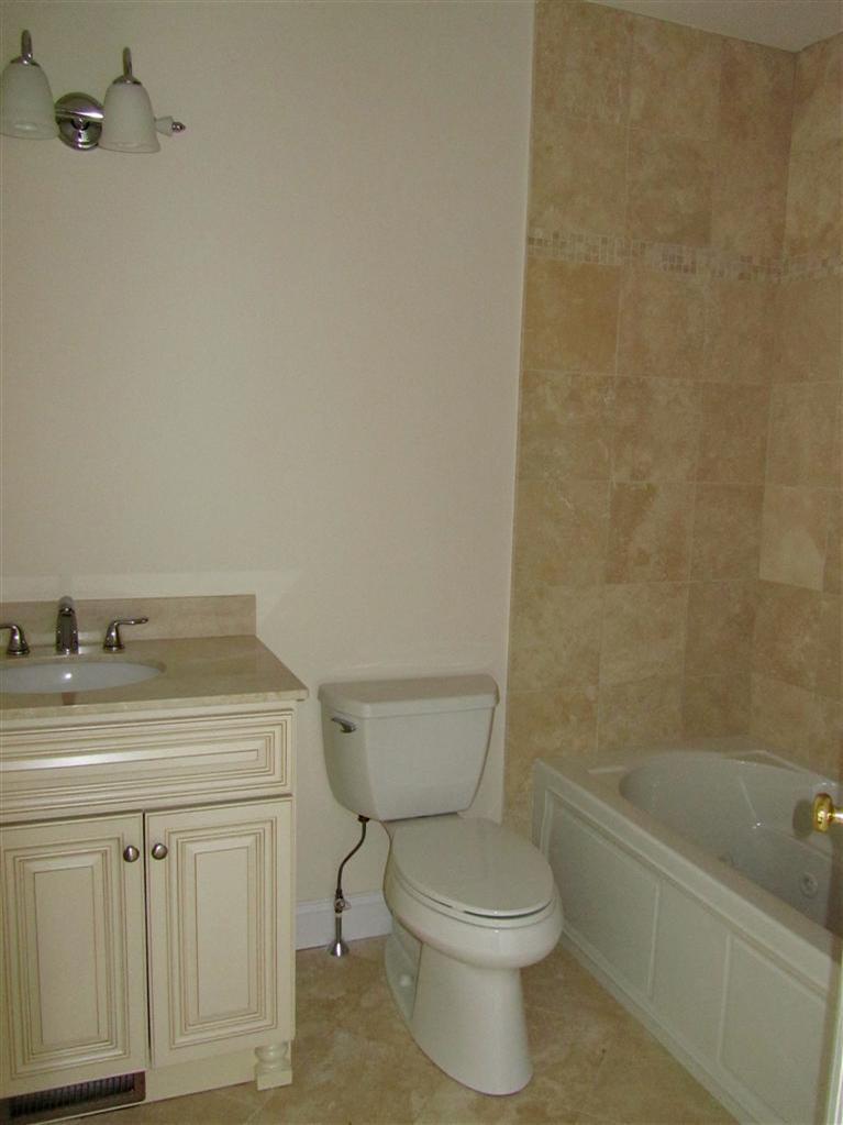 161 Route 28, Unit 7 West Harwich, MA 02671 - Photo 9 of 16 a bathroom with a sink a toilet and bathtub